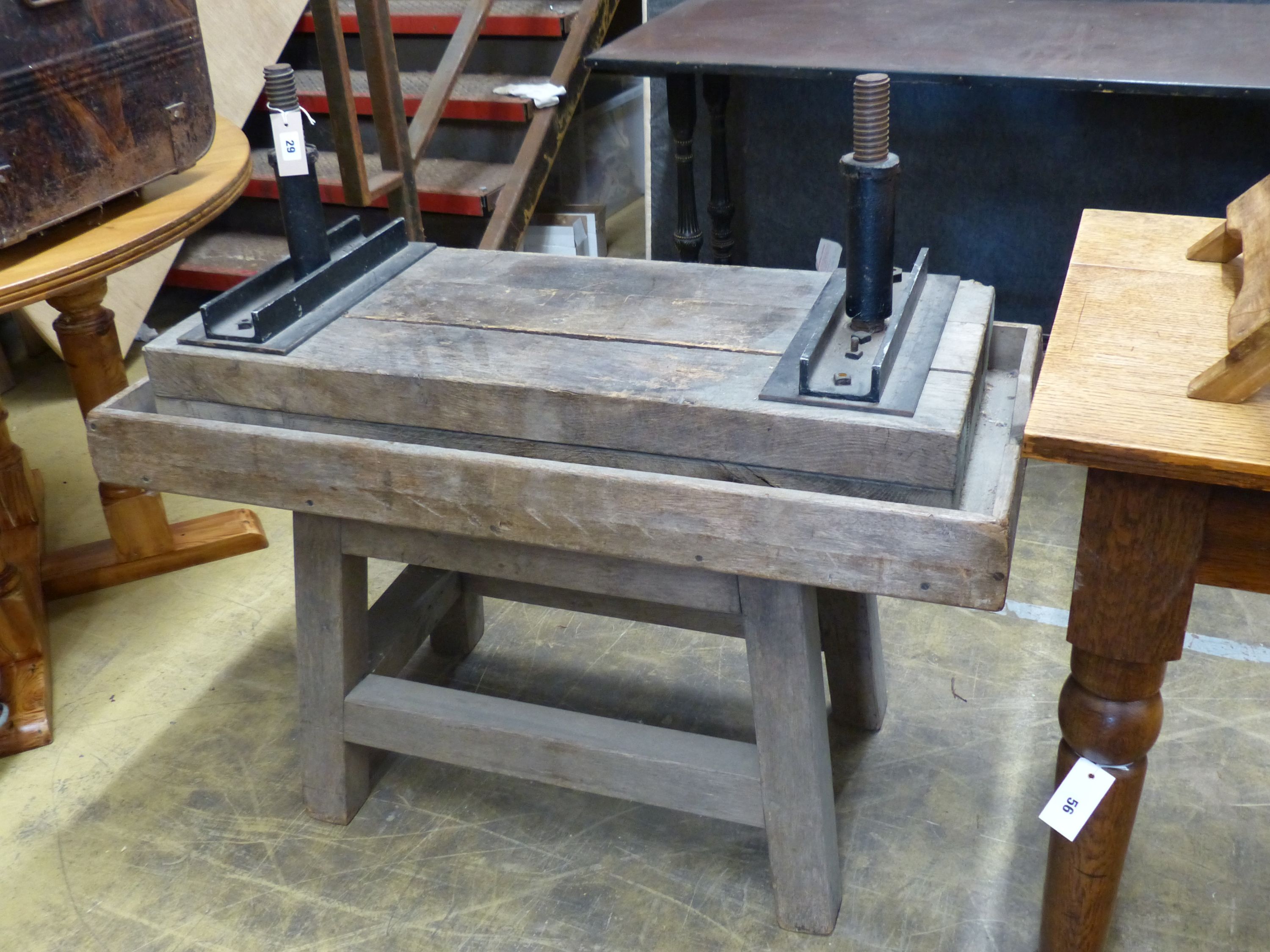 An antique wood and cast iron twin-screw cider press on stand, width 102cm, depth 49cm, height 90cm